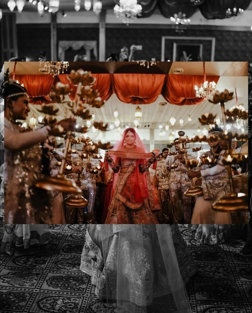 1)Indian bride strolling into a decorated wedding site, amidst festive lamps and festivities.
