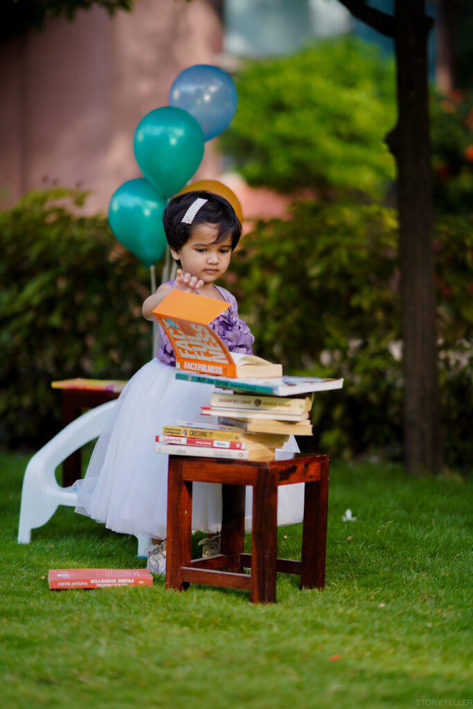 baby girl photoshoot giving pose with books